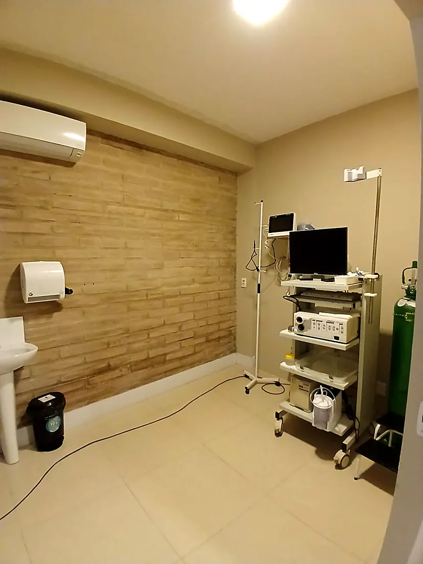 Ambiente interno da LM Serviços Médicos com equipamentos e parede em tijolo aparente